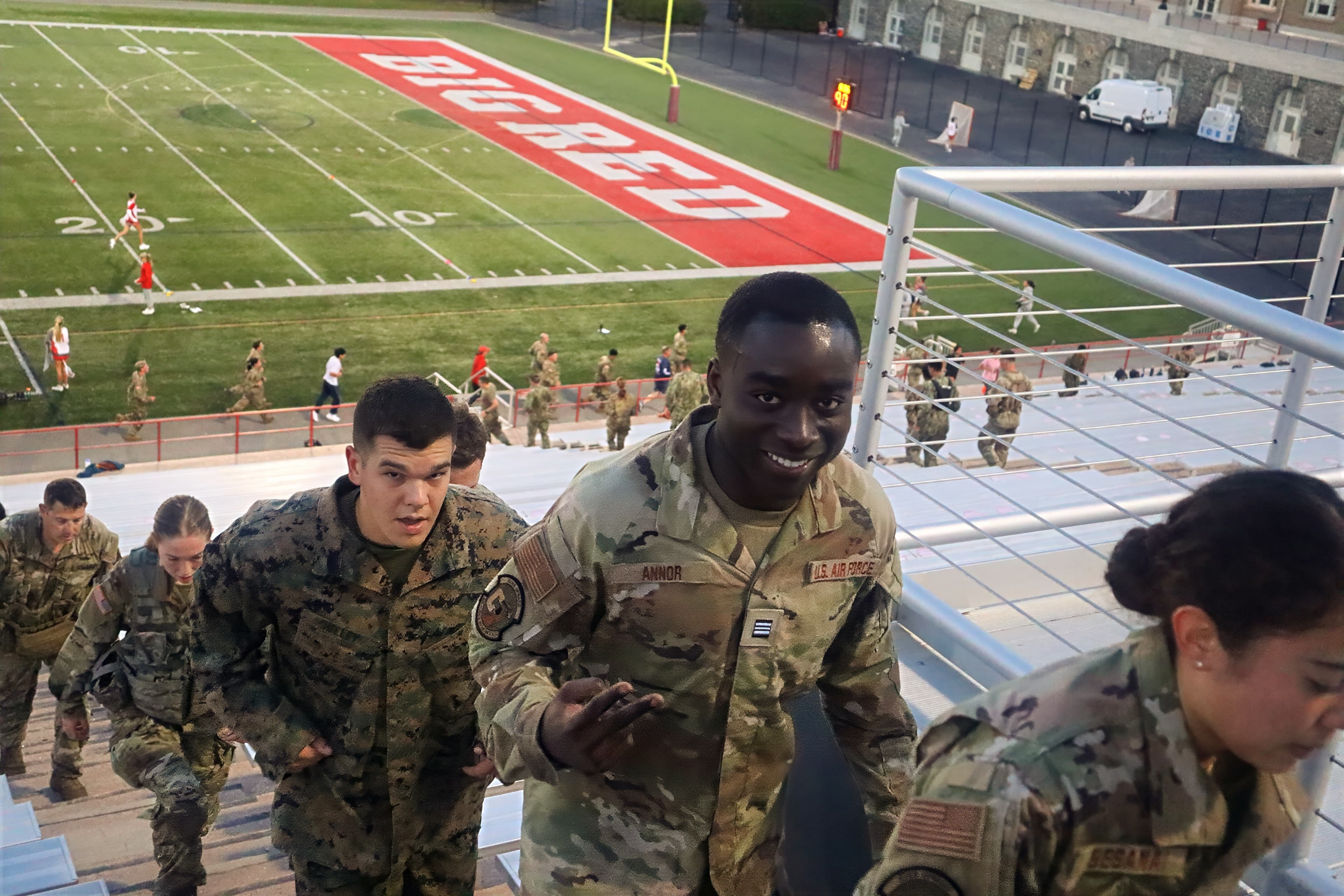 Cadets from different services climb the stadium bleachers together during the 9/11 memorial workout.