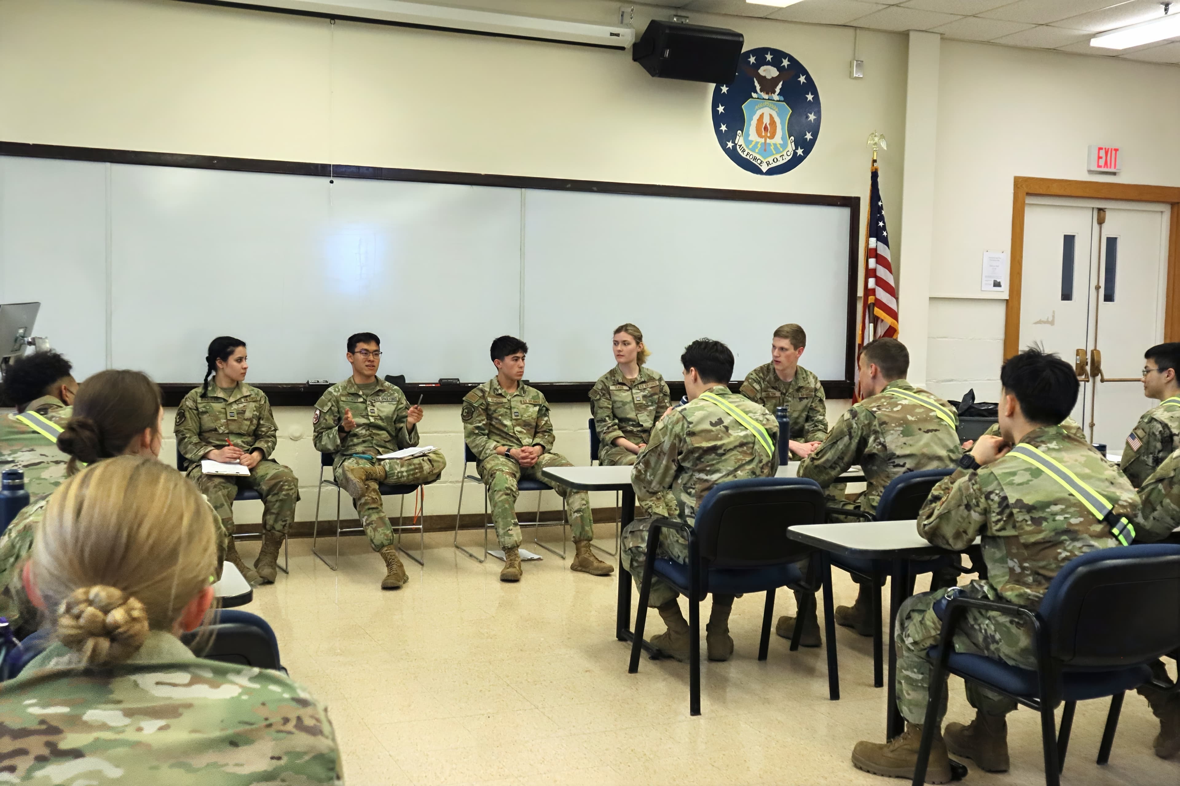 Cadets seated in a circle for an open discussion in the detachment classroom.
