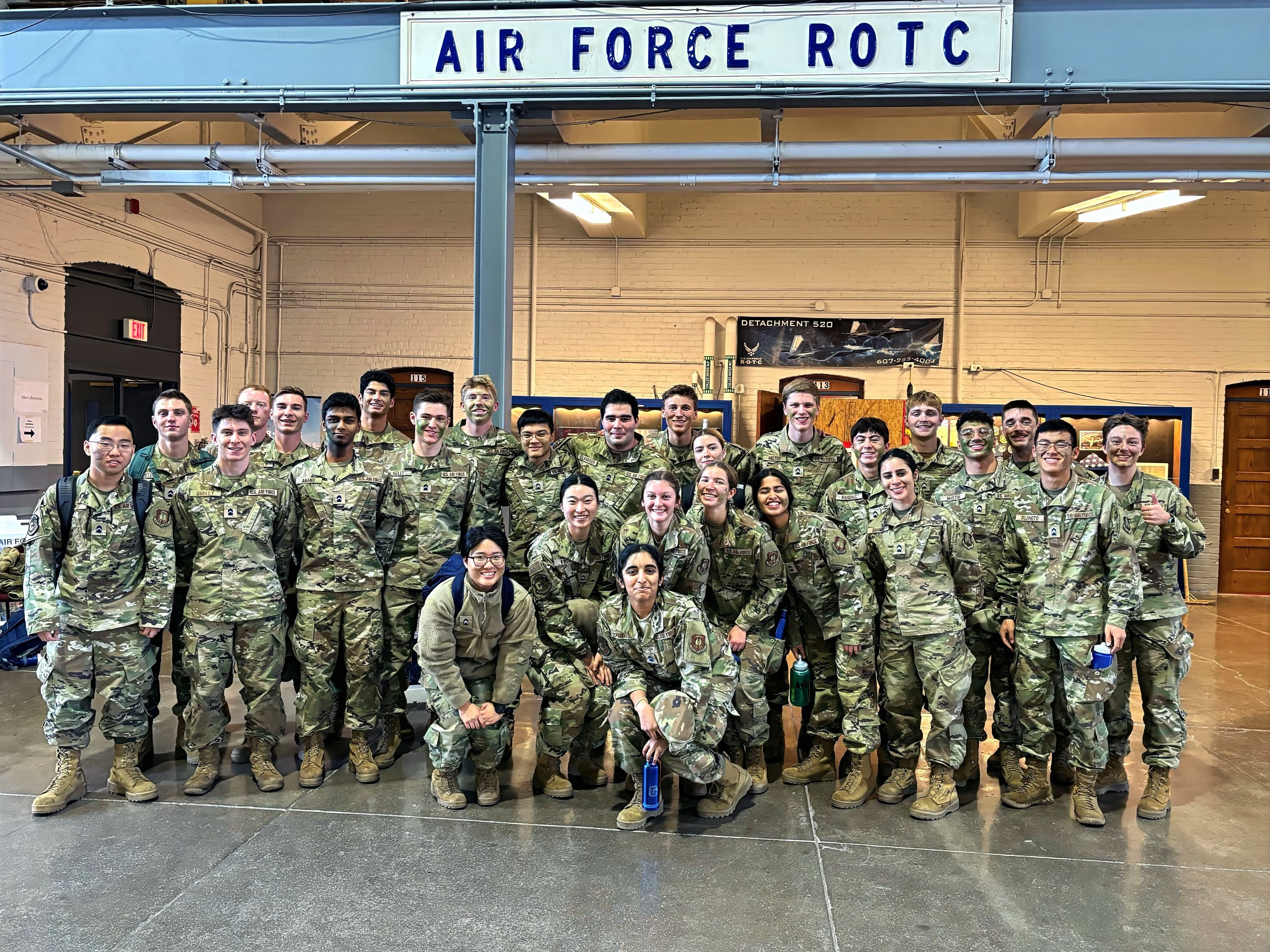 The detachment gathered for a group photograph beneath the Air Force ROTC sign in Barton Hall.