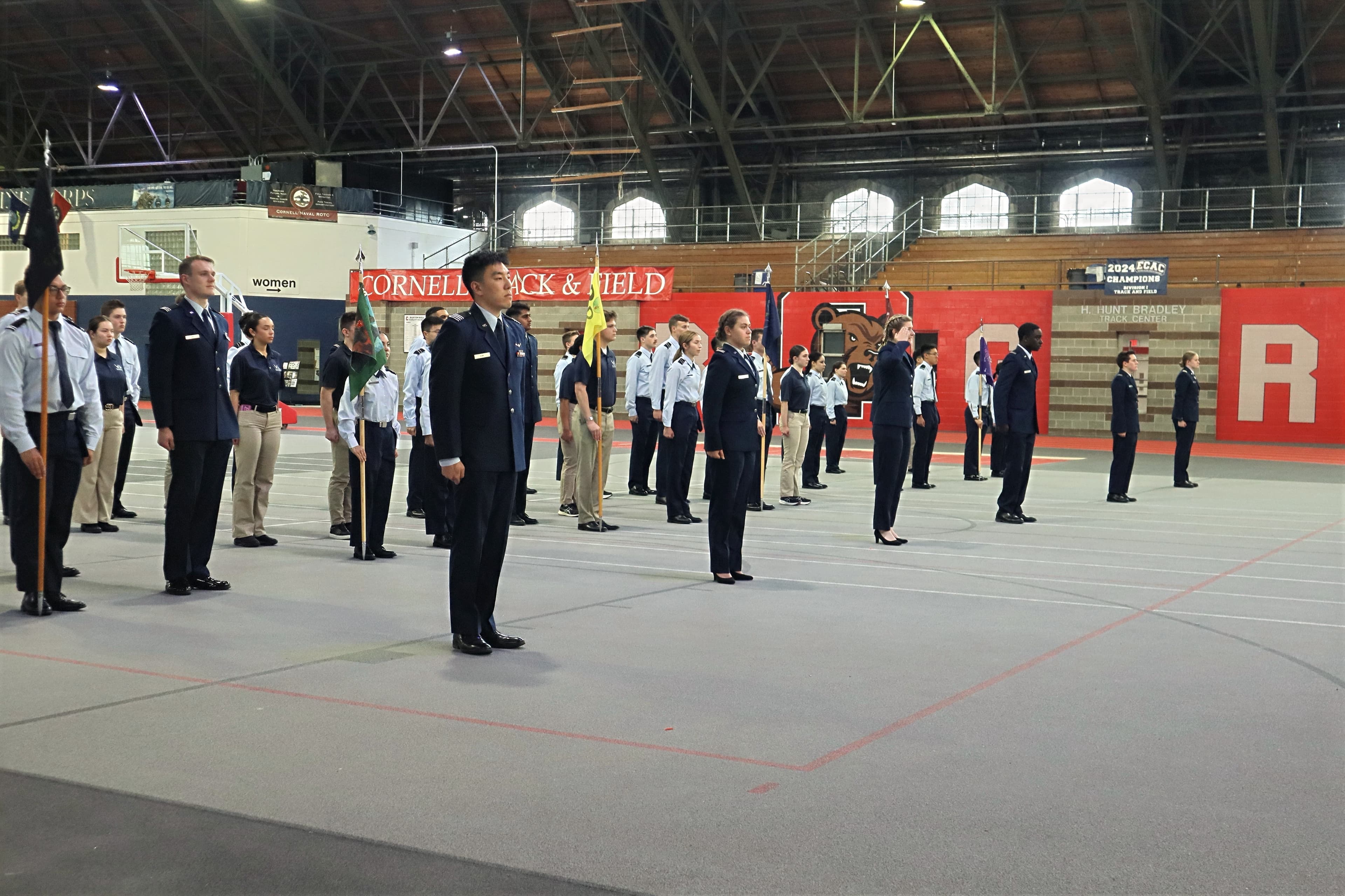 Cadets in dress blues stand for a uniform inspection in Barton Hall.
