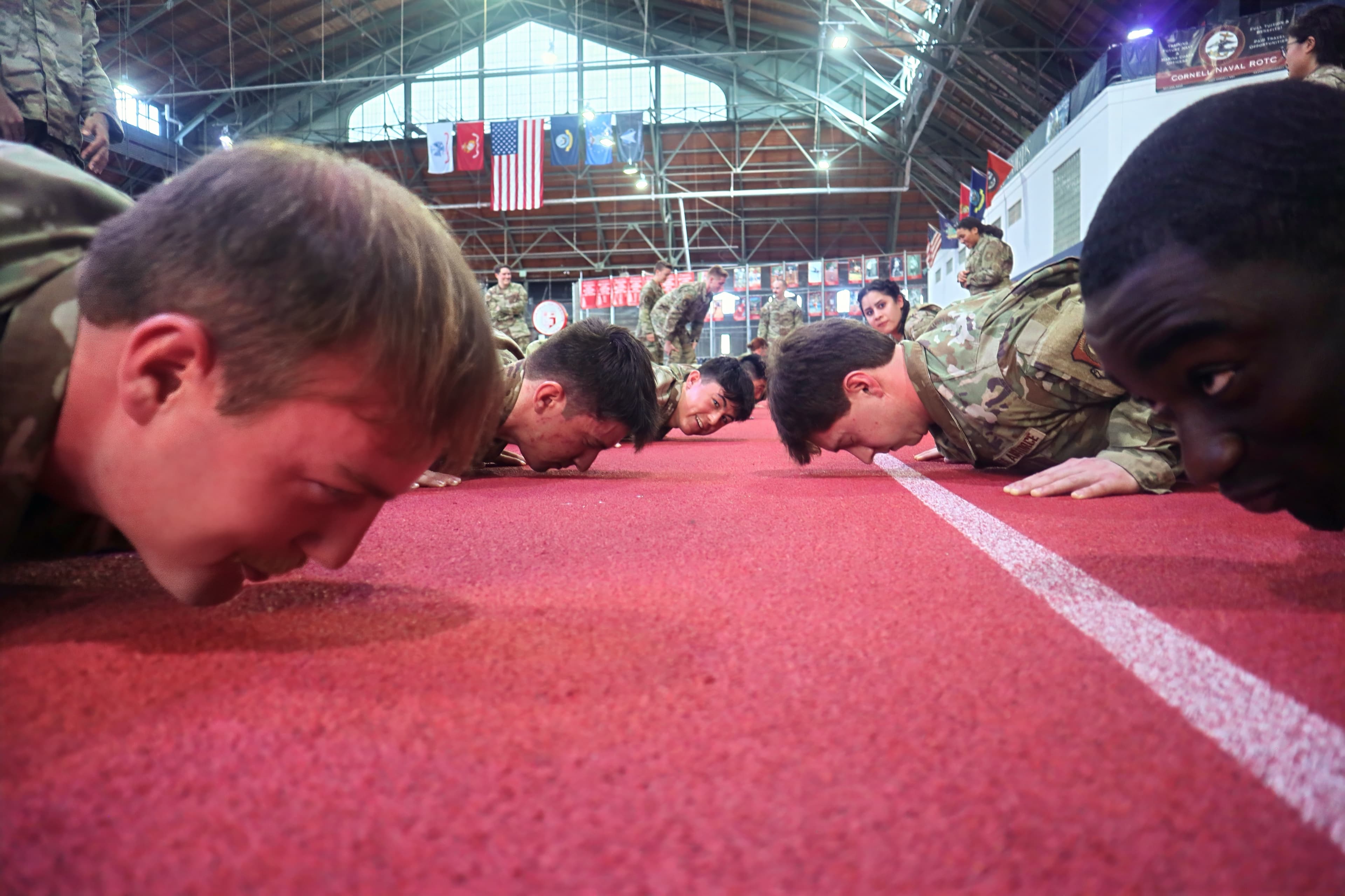 A low angle along a line of cadets at the bottom of a pushup.