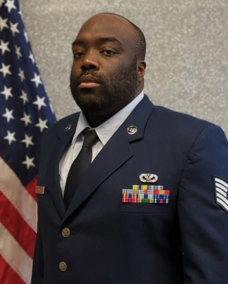 Official portrait of TSgt. Jalen J.A. Gayle in service dress before the United States flag.