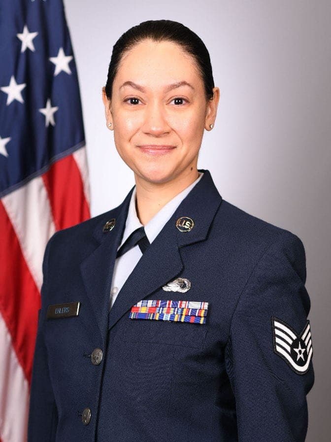 Official portrait of SSgt. Samantha M. Ehlers in service dress before the United States flag.