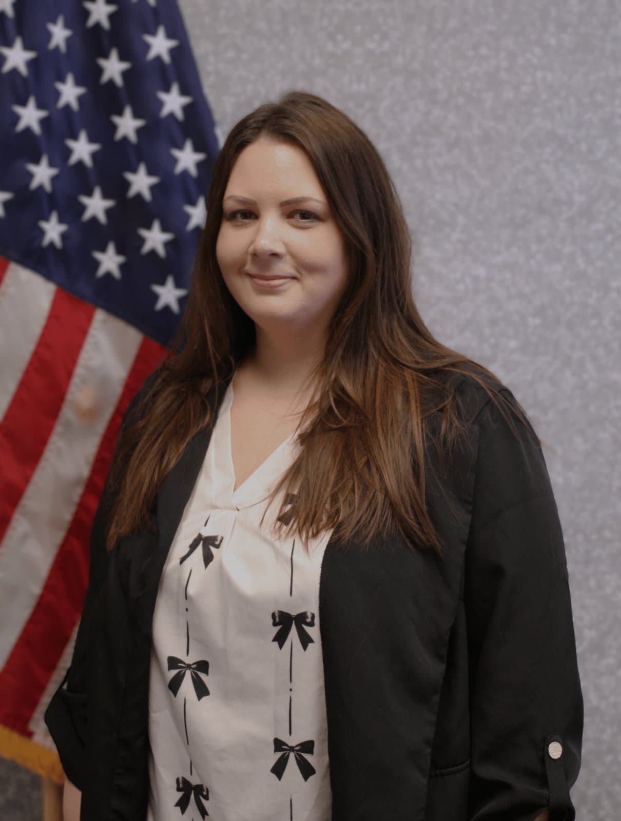 Portrait of Ms. Jessica Hammond before the United States flag.